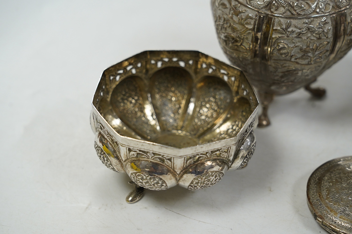 A pair of Indian pierced cusped white metal bowls, diameter 84mm, three other Indian white metal canisters and a Middle Eastern pill box. Condition - fair